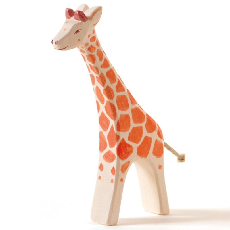Wooden giraffe toy with orange spots on a white background