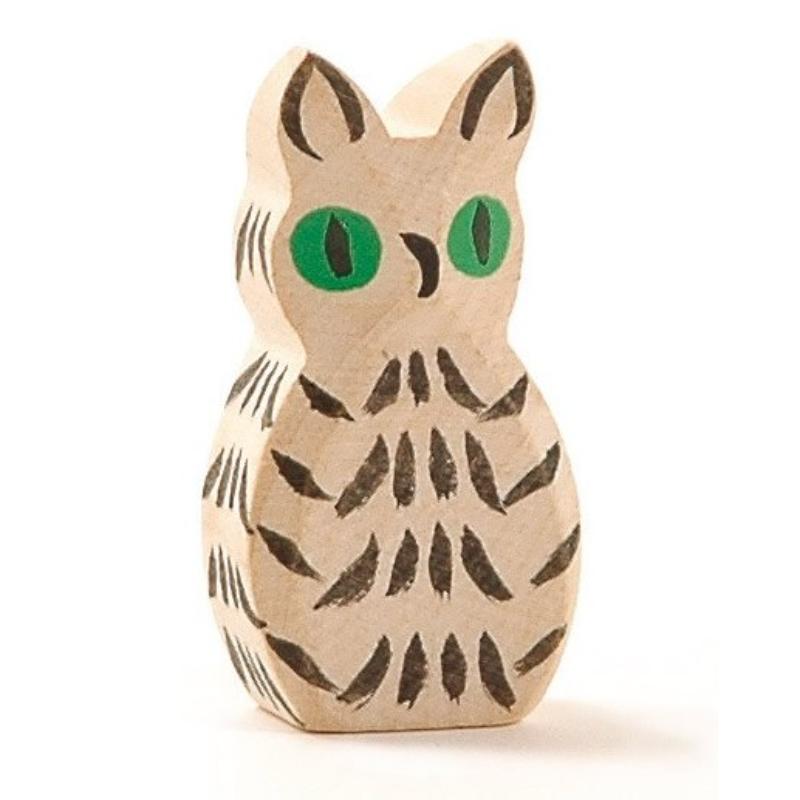 Wooden owl figurine with green eyes on a white background