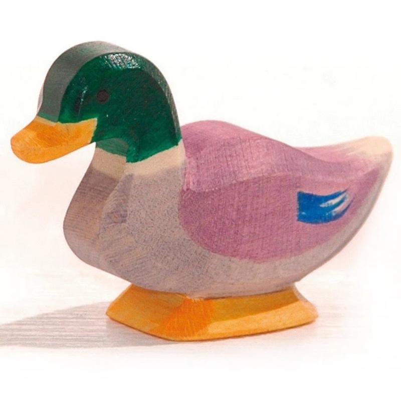 Wooden duck figurine with a green head and pink body on a white background
