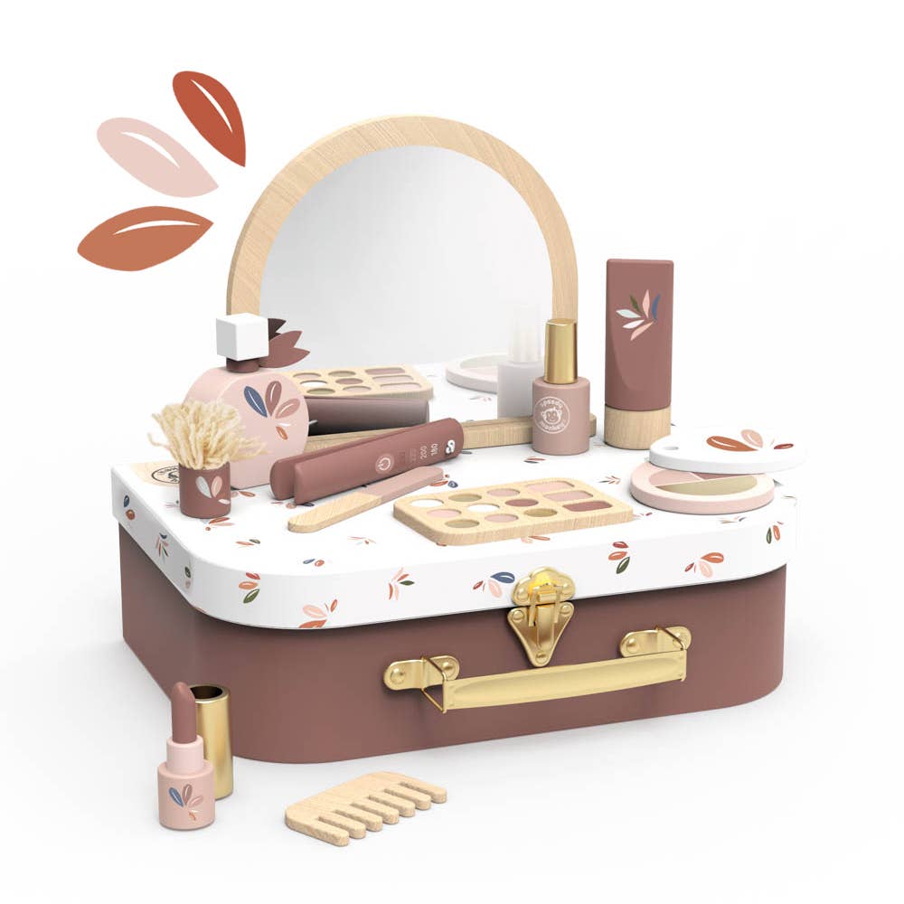 Toy makeup set with mirror, tools, and cosmetic items on a white background