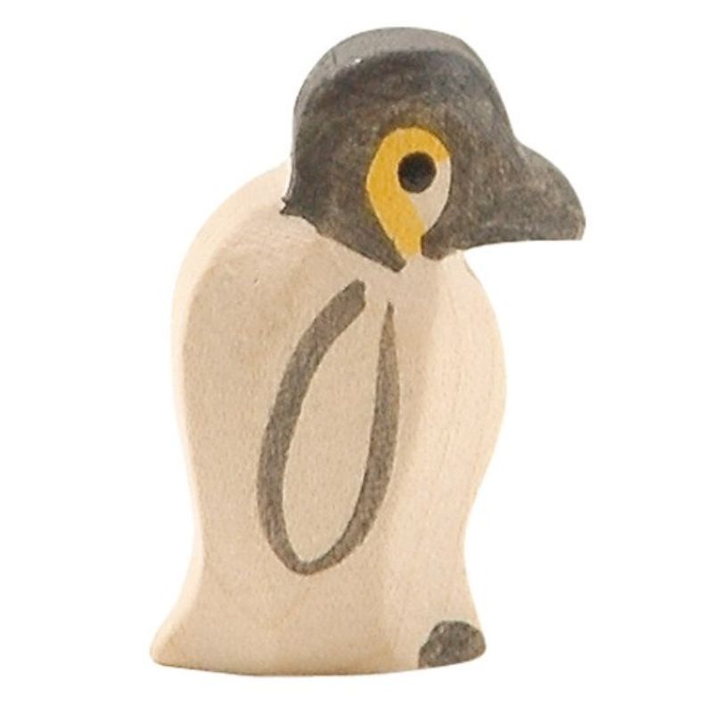 Wooden penguin figurine on a white background