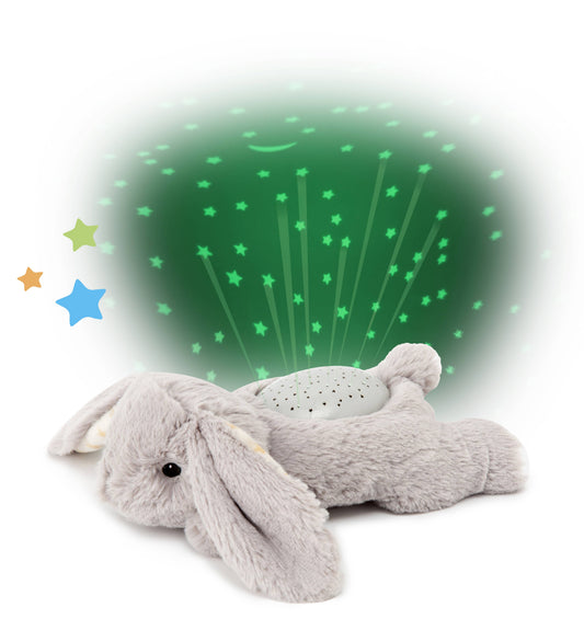 Gray plush bunny toy with star projector on a white background