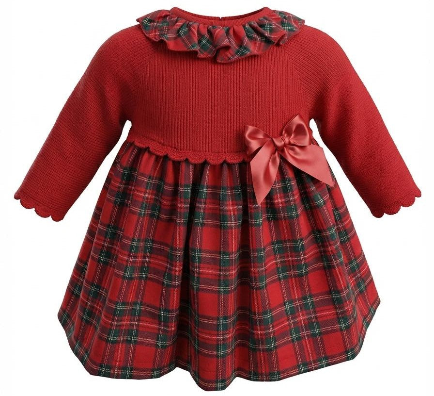 A baby girl's holiday-themed dress with a solid red ribbed knit long-sleeve top, a red and green plaid skirt, a red ruffled collar, and a red satin bow on the side.