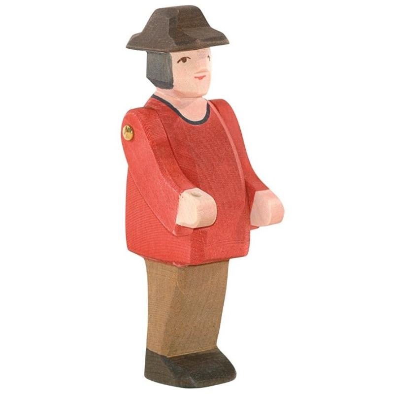 Wooden figurine of a person wearing a red jacket and brown hat on a white background