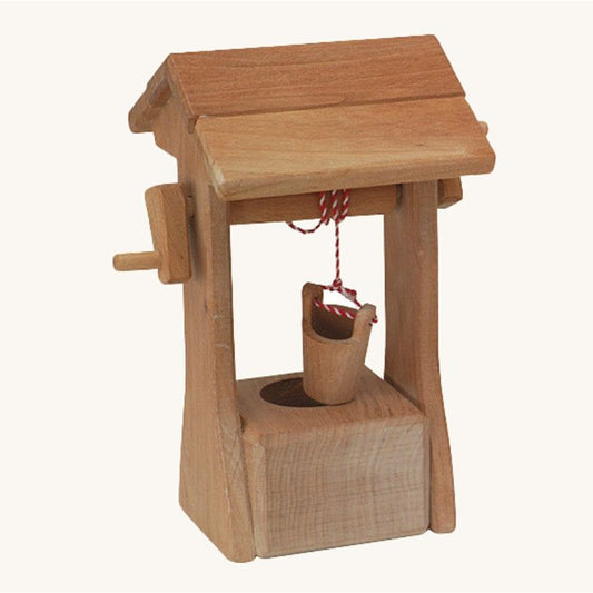 Wooden wishing well with a bucket on a white background