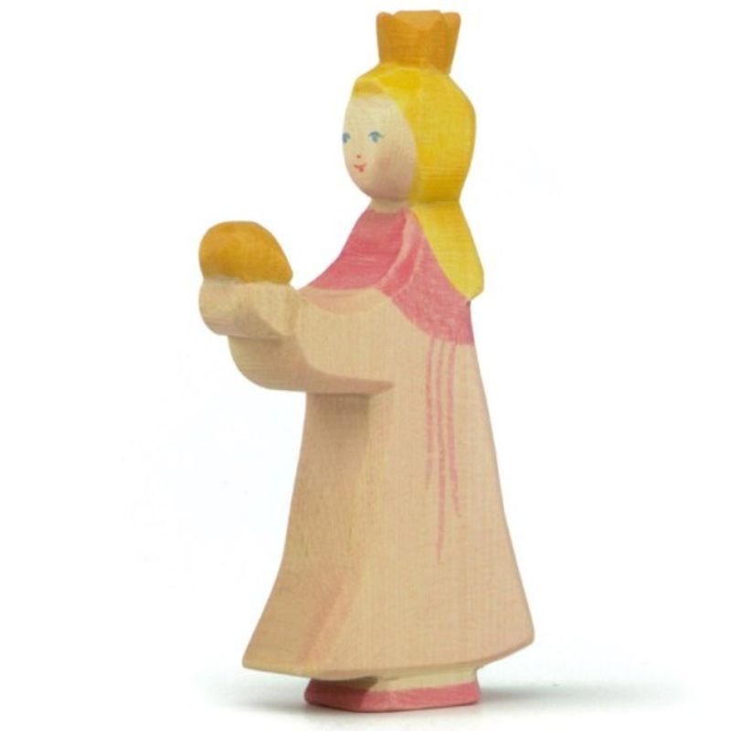 Wooden figurine of a girl with a yellow dress and pink shoes on a white background